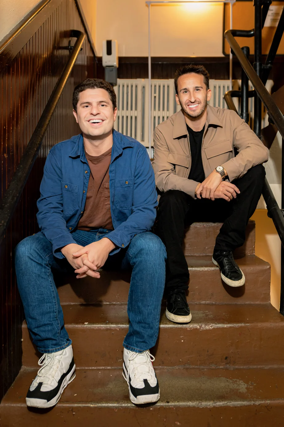 Brandon and Harrison, creators of UpDating, sitting on backstage stairs